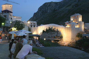 Residents look at the reconstructed Old Bridge of Mostar, Bosnia and Herzegovina. July 16, 2004. [&#169; AP Images]