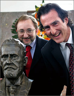 Craig C. Mello, right, and Andrew Z. Fire pose next to a statue of German scientist Paul Ehrlich after being awarded the Paul Ehrlich and Ludwig Darmstaedter award March 14 in Frankfurt, Germany.