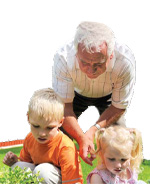 Photo of an elderly man watching over playing children