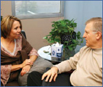 Photo of an elderly man talking to a counselor