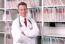 Doctor standing in front of bookshelf