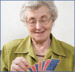 Photo of an elderly woman playing cards