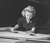 Woman at a drafting table.