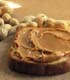 peanut butter spread on bread slice ©