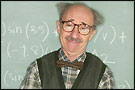 A professor smiles in front of a blackboard filled with math equations
