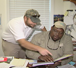 Jeremy Martin (left) goes over a conservation plan with Walton County District Conservationist Darryl Williams