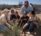 Teacher and students studying at a farm.