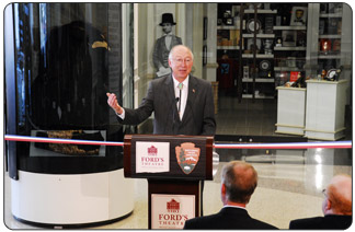 Secretary of the Interior Ken Salazar addresses the crowd at the re-opening ceremony for Ford's Theatre on Feb. 11, 2009.  Behind him is a case with President Abraham Lincoln's Great Coat, which he wore on the night of his assassination as well as for his Second Inaugural address.  Secretary Salazar said that President Obama considers President Lincoln a model for how he  handled the war and economic turmoil of his time. P[hoto by Terry Adams, National Park Service]