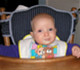 Infant Eating in a High Chair