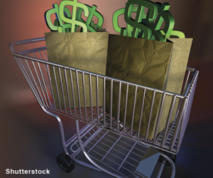 Photo: Shopping cart with dollar signs in bags