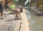 repairing Loop canal banks eroded from the hurricane preventing further damage to homes along the waterway