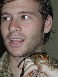 Photo of man holding a brown frog