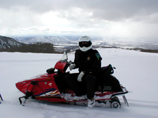 Ranger patrolling on snowmobile.