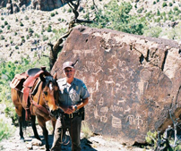 Ranger on horse patrol at petroglyph site.