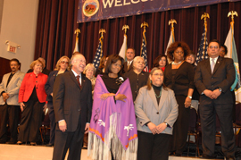 Obama wearing purple shawl and standing between Interior Secretary Salazar and Public Affairs Director Nedra Darling