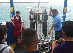 image of teens surrounding testing equipment