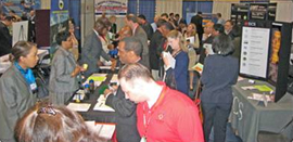 employees interacting with visitors at visitors fair