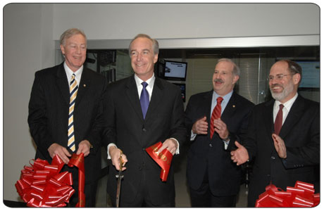 Secretary Dirk Kempthorne, center, cuts the ceremonial ribbon officially opening the Interior Operations Center, a state-of-the-art communications facility that will improve the Department's ability to respond to emergencies and natural disasters.  At right is Larry Parkinson, Deputy Assistant Secretary for Law Enforcement and Security; second from right is Larry Broun, Director of the Office of Emergency Management; at far left is Chuck Franklin, Office of Emergency Management. [Photo by Tami Heilemann, NBC]