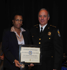 Then Acting Deputy Chief Sal Lauro presenting Jacqueline Anderson-Parker with a retirement certificate.