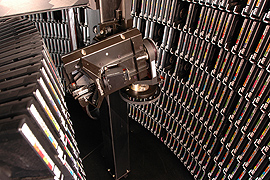 robotic arm with vast shelves of data on either side