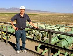 man standing by geothermal generating equipment