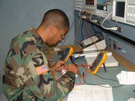 Photo of Soldier testing a circuit