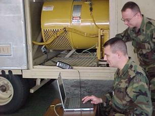 Photo of Soldiers using cat E-Tools to analyze a generator engine