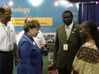 Larry Clark, NRCS Deputy Chief for Science and Technology, and Agriculture Secretary Ann M. Veneman greet African delegates visiting the NRCS booth