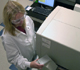 Heather Sullivan works on the RT-PCR thermocycler at the USDA National Wildlife Research Center in Fort Collins, Colorado.