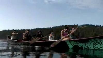 video screenshot people rowing on a canoe