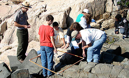 Park ranger and kids explore intertidal areas.