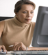 Woman looking with interest at a computer screen.