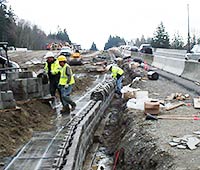 Crews build an earth wall for the new SR 16 Burley Olalla interchange