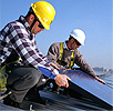 Thumbnail photo of two men installing a photovoltaic module on the roof of a building.
