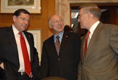 Secretary Salazar confers with Senators  Byron L. Dorgan, right, and John Barrasso, left.