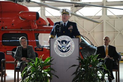 Commandant of the Coast Guard Admiral Thad Allen speaks at the Coast Guard Service Secretary Transfer of Authority in Washington, D.C., March 23, 2009, flanked by Secretary Napolitano and former Secretary Chertoff