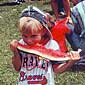 Young boy eating a large piece of watermelon