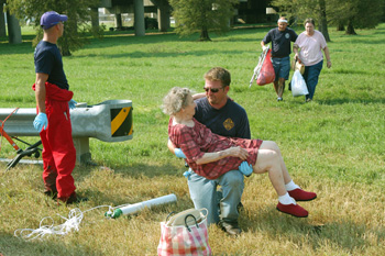 New Orleans, La., August 31, 2005 -- A firefighter holds an elderly woman rescued from the floodwaters caused by Hurricane Katrina. The elderly made up a good percentage of those stranded by the storm. The City of New Orleans is being evacuated following hurricane Katrina. Photo by Win Henderson / FEMA photo
