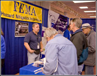 Mitigation specialist Jose Ruvira talks with visitors to the FEMA Mitigation booth at the Grays Harbor Trade Fair