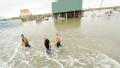 Local Residents walk thorugh Texas floodwaters