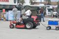 A resident riding his lawn mower into a food distribution center