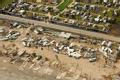 Aerial of damaged beach front mobile home park in Texas