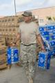 Army National Guard holds water at a food distribution site in Texas