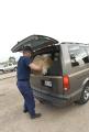 Coast Guardsman puts MREs in a residents car in Texas