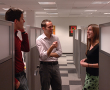 Employees strategize in the hallway