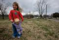 Child standing in a FEMA mitigation area in Missouri