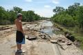 Resident looks at a damaged road in Iowa