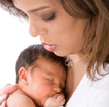 Photo of a woman holding an infant.