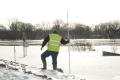 A City Engineer measures the level of ice and water, East Dike, Fargo
