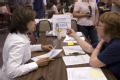 Nancy Montanez-Johner and a FEMA worker at a DRC in Iowa